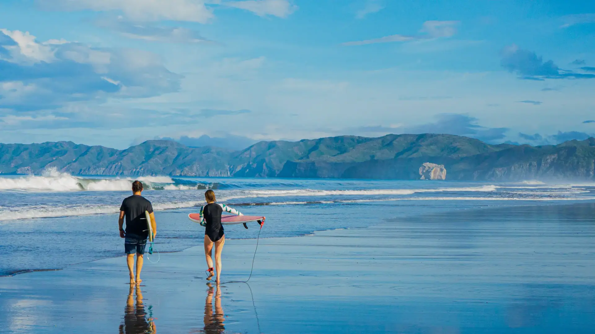 Couple standing on the shoreline at Brasilito
